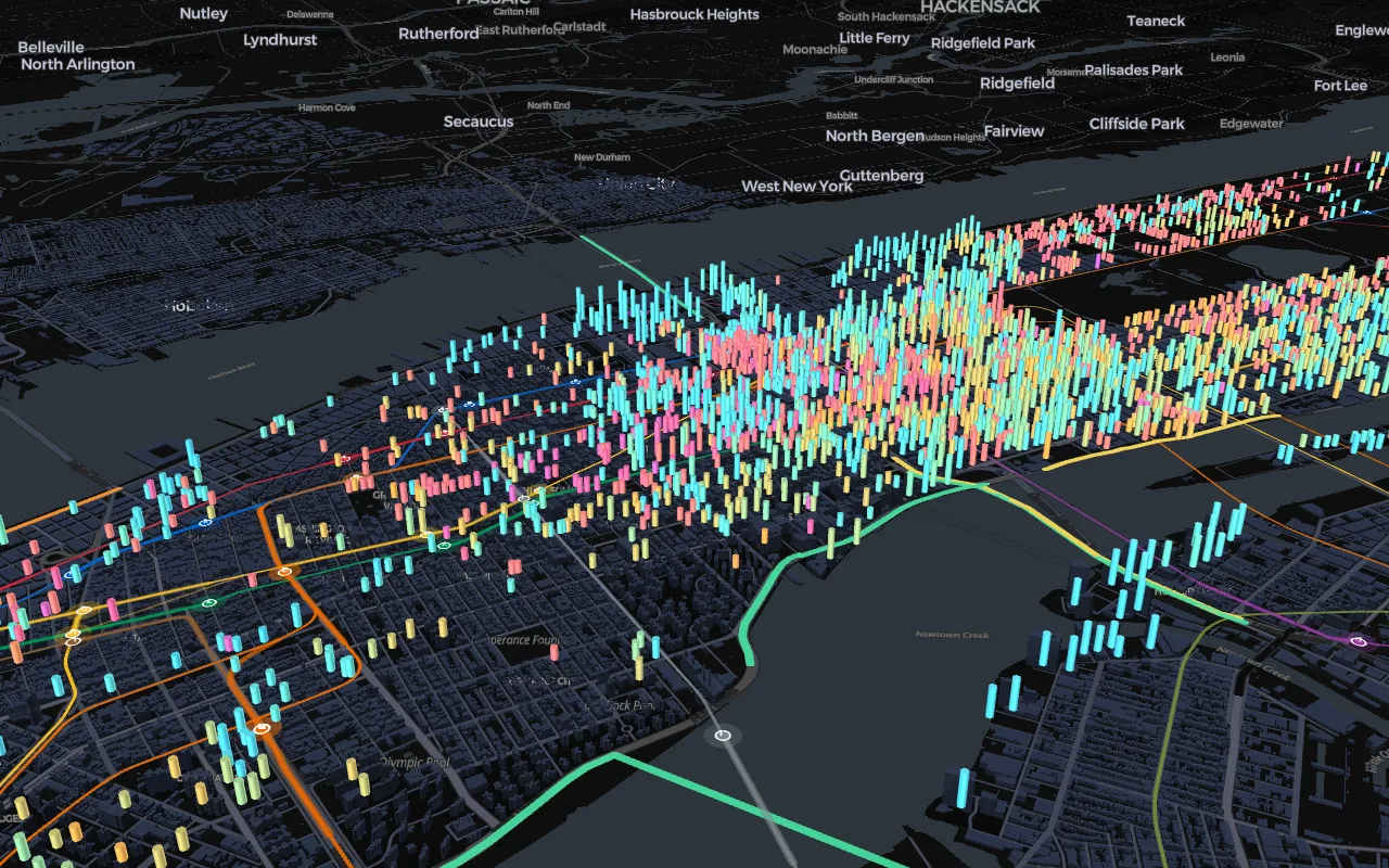 3D map of Midtown Manhattan with buildings drawn as columns colored by year built and live subway lines